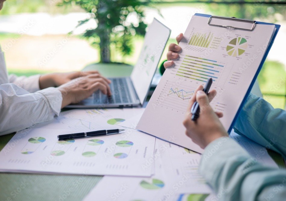 Business professionals analyzing Common Pitfalls to avoid when picking a policy on a clipboard and laptop.