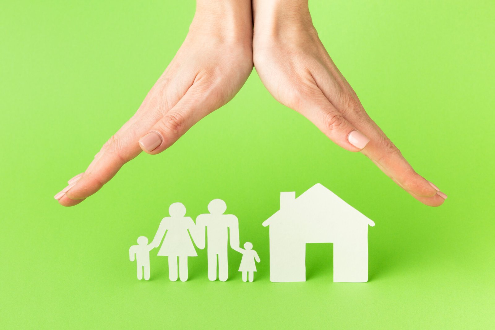 Home and Propert Insurance Symbolic Hands Protecting Paper Family and House Cutouts.