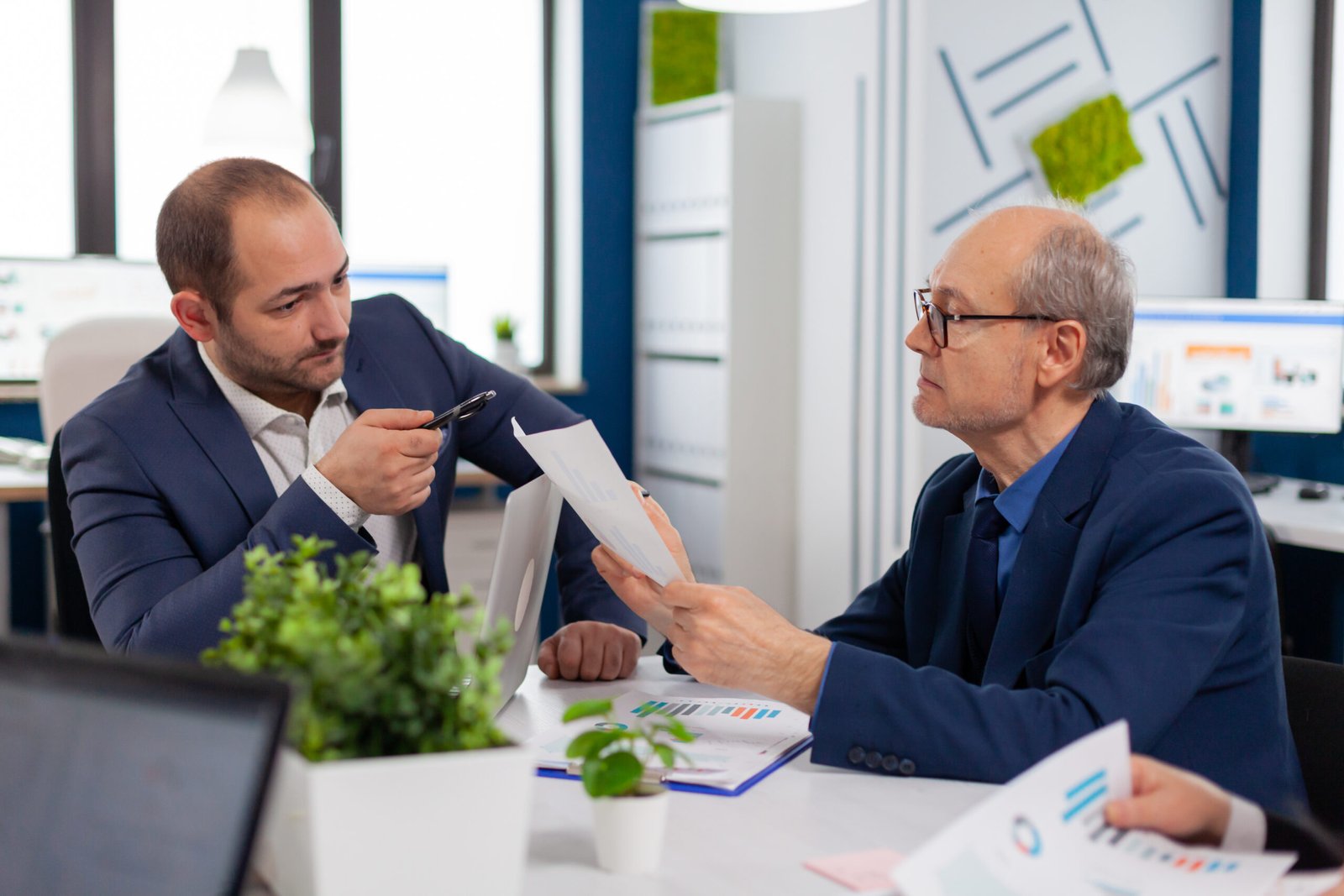 Professionals Reviewing Commercial Insurance Documents in Office